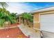 Front entry with walkway, landscaping, and a white door at 14143 Saul Ln, Port Charlotte, FL 33981