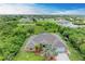 Aerial view of single-Gathering home with pool and large backyard, located in a residential neighborhood at 14143 Saul Ln, Port Charlotte, FL 33981