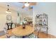 Dining area with a round table, four chairs, and a decorative shelf at 14143 Saul Ln, Port Charlotte, FL 33981