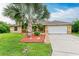 Single-Gathering home with a well-manicured lawn and palm trees at 14143 Saul Ln, Port Charlotte, FL 33981