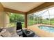 Screened patio with pool, grill and seating at 14143 Saul Ln, Port Charlotte, FL 33981
