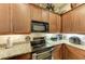 Kitchen boasts stainless steel appliances and granite countertops at 14143 Saul Ln, Port Charlotte, FL 33981