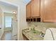 Laundry room includes washer, dryer, and extra storage at 14143 Saul Ln, Port Charlotte, FL 33981