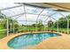 Inviting kidney shaped pool with screened enclosure at 14143 Saul Ln, Port Charlotte, FL 33981