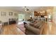 Open living space with hardwood floors, view of pool and kitchen at 14143 Saul Ln, Port Charlotte, FL 33981
