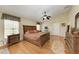 Large main bedroom with hardwood floors and ensuite bathroom at 14143 Saul Ln, Port Charlotte, FL 33981