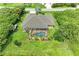 Aerial view showcasing the home's pool and screened enclosure in a lush green backyard at 14143 Saul Ln, Port Charlotte, FL 33981