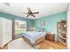 Guest bedroom with hardwood floors and large window at 14143 Saul Ln, Port Charlotte, FL 33981