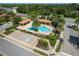 Community pool with a large deck, landscaping, and accessible parking at 1012 Bradberry Dr, Nokomis, FL 34275