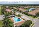 Community pool with a large deck, landscaping, and accessible parking at 1012 Bradberry Dr, Nokomis, FL 34275