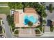 Community pool with a large deck, landscaping, and accessible parking at 1012 Bradberry Dr, Nokomis, FL 34275