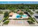 Community pool with a large deck, landscaping, and accessible parking at 1012 Bradberry Dr, Nokomis, FL 34275