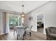 Bright dining area with glass table and seating for four at 10168 Willowood Ave, Englewood, FL 34224
