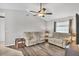 Comfortable living room featuring two sofas and a ceiling fan at 10168 Willowood Ave, Englewood, FL 34224