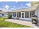 Large backyard patio with grill and view of house at 10168 Willowood Ave, Englewood, FL 34224