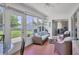 Relaxing sunroom with wicker furniture and view of backyard at 10168 Willowood Ave, Englewood, FL 34224