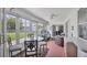 Relaxing sunroom with seating area, table, and backyard access at 10168 Willowood Ave, Englewood, FL 34224