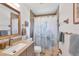 Clean bathroom with shower/tub combo, vanity, and updated fixtures at 10168 Willowood Ave, Englewood, FL 34224