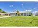 Ranch-style home with gray exterior, screened porch, and large yard at 10168 Willowood Ave, Englewood, FL 34224