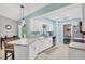 Updated kitchen with white cabinets and light teal walls at 10168 Willowood Ave, Englewood, FL 34224