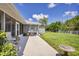 Spacious backyard with patio, grill, and grassy area at 10168 Willowood Ave, Englewood, FL 34224
