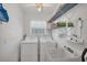 Bright laundry room with washer, dryer and utility sink at 10168 Willowood Ave, Englewood, FL 34224