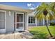 Front entrance with screened porch and landscaping at 10168 Willowood Ave, Englewood, FL 34224