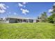 Large backyard with shed and view of home at 10168 Willowood Ave, Englewood, FL 34224