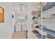 Laundry room with washer, dryer, and storage shelves at 10168 Willowood Ave, Englewood, FL 34224