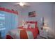 Bright bedroom with coral bedding, white accents, and coastal decor at 10136 Amy Ter, Port Charlotte, FL 33981