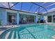 Inviting pool area with a covered patio and outdoor dining at 10136 Amy Ter, Port Charlotte, FL 33981