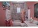 Clean bathroom with pink walls, gray tile, and a floral shower curtain at 10136 Amy Ter, Port Charlotte, FL 33981