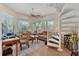 Home office with spiral staircase, built-in shelving, and hardwood floors at 200 Capstan Dr, Placida, FL 33946