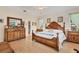 Bright main bedroom with hardwood floors, a king bed and an ensuite bathroom at 200 Capstan Dr, Placida, FL 33946