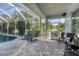 Relaxing screened-in patio with poolside lounge chairs at 200 Capstan Dr, Placida, FL 33946