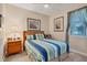 Cozy bedroom with striped bedding and wood framed bed at 200 Capstan Dr, Placida, FL 33946
