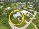 Bird's eye view of a waterfront home with a circular driveway and lush landscaping at 200 Capstan Dr, Placida, FL 33946