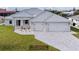 Two-story home with attached two-car garage and metal roof at 15267 Appleton Blvd, Port Charlotte, FL 33981
