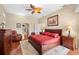 Comfortable main bedroom with wood floors, ceiling fan, and ample natural light at 10 Coral Creek Pl, Placida, FL 33946