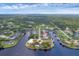 Stunning aerial view of waterfront property with private dock and lush landscaping at 3058 Mauck Ter, Port Charlotte, FL 33981