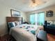 Main bedroom with a queen bed and sitting area at 208 Marlette Dr, North Port, FL 34287