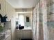 Bathroom with a nautical-themed shower curtain and updated vanity at 208 Marlette Dr, North Port, FL 34287