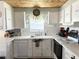 Kitchen with white cabinets, mosaic backsplash, and stainless steel appliances at 208 Marlette Dr, North Port, FL 34287
