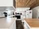 White kitchen with wood-look floors and ample counter space at 208 Marlette Dr, North Port, FL 34287