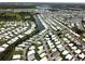 Aerial view of waterfront community with numerous mobile homes at 208 Marlette Dr, North Port, FL 34287