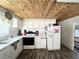Updated kitchen with white cabinets, mosaic backsplash, and wood-look floors at 208 Marlette Dr, North Port, FL 34287