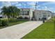 Mobile home with a palm tree and spacious yard at 208 Marlette Dr, North Port, FL 34287
