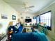 Bright living room featuring comfortable seating and a large TV at 208 Marlette Dr, North Port, FL 34287