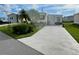 Mobile home with carport and nicely landscaped area at 208 Marlette Dr, North Port, FL 34287