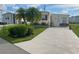 Inviting exterior with a spacious driveway and landscaping at 208 Marlette Dr, North Port, FL 34287